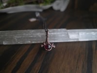 Image 1 of Mink vertebra with garnet 