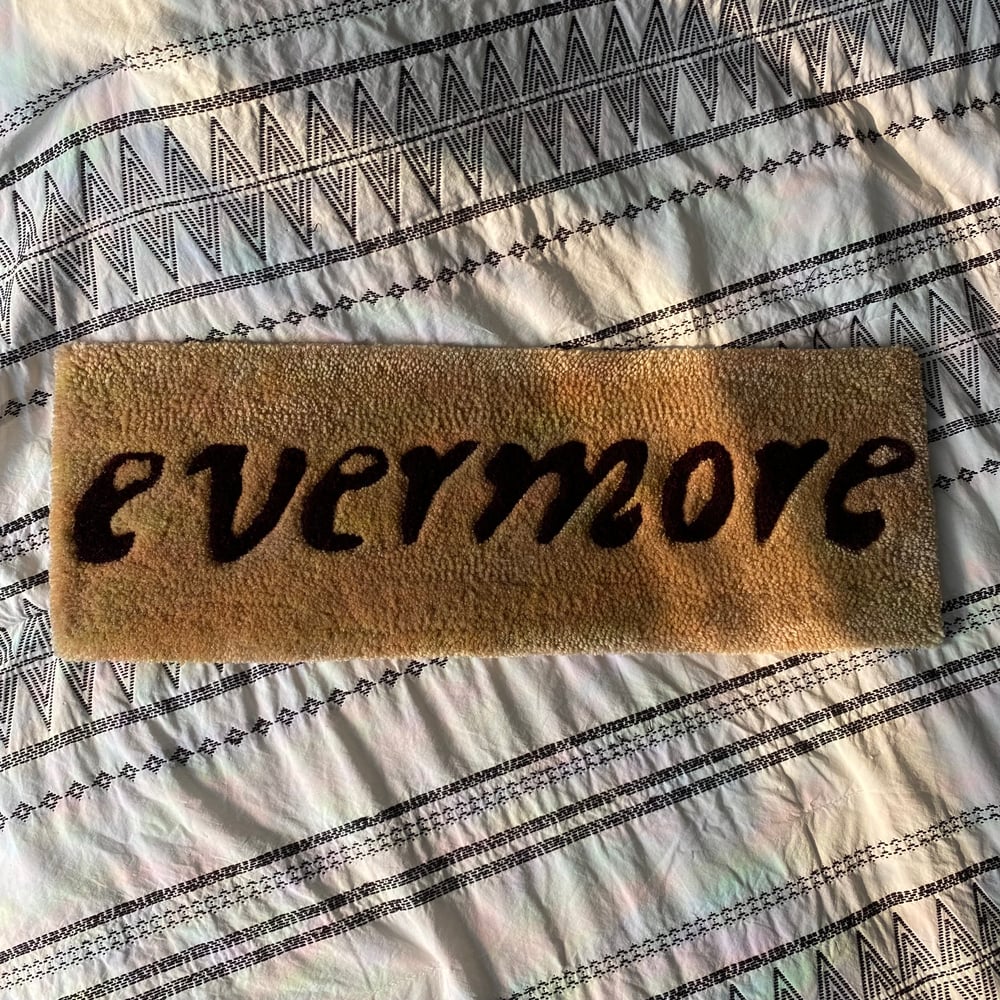 Image of evermore title wall rug