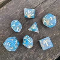 Image 1 of BLUE MARBLE POLYHEDRAL DICE SET semi-opaque base with gold flake inclusions