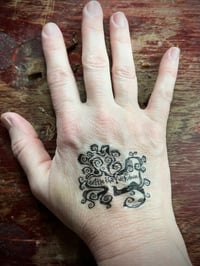 Image 1 of settle temp tattoo