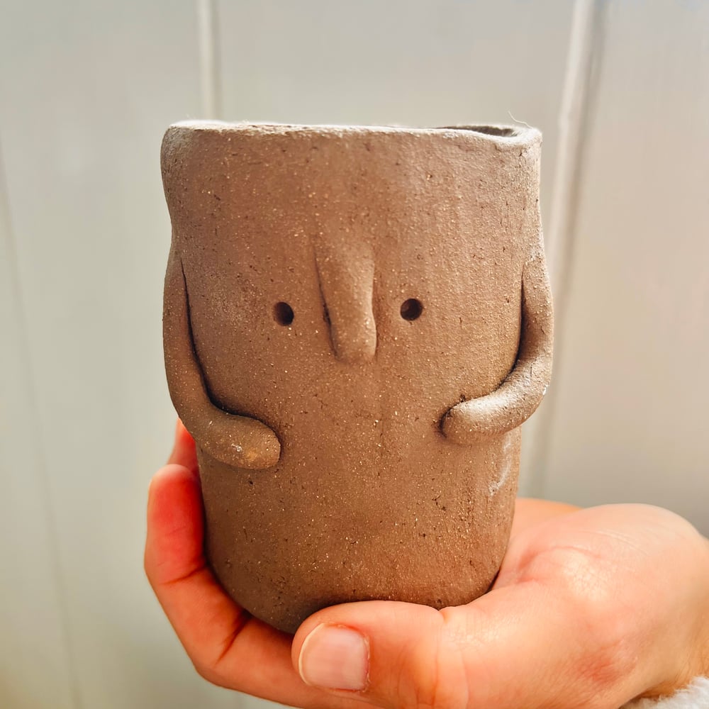 Image of Brown clay pot person 