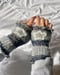 Image of striped ombre handwarmers in storm