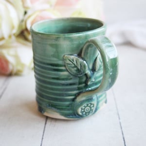 Image of Shimmering Green Pottery Mug with Floral Details, Coffee Cup 12 oz., Made in USA