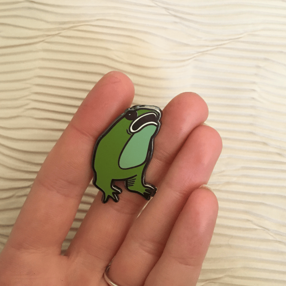 Armless frog enamel pin