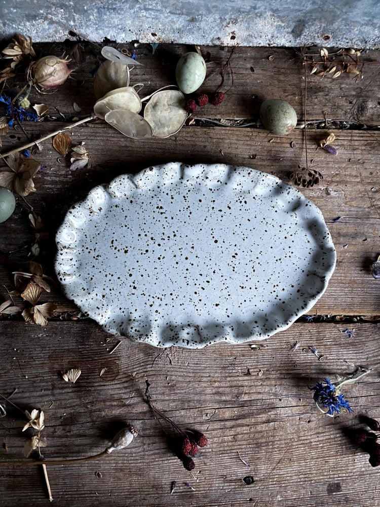 Image of White speckled frilly oval plate