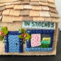 Image 2 of "In Stitches"  quilt shop pincushion