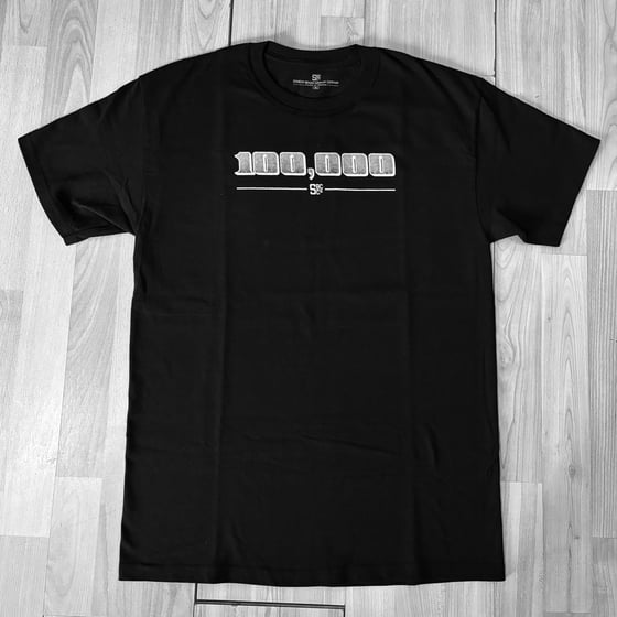 Image of 100 Grand tee. 