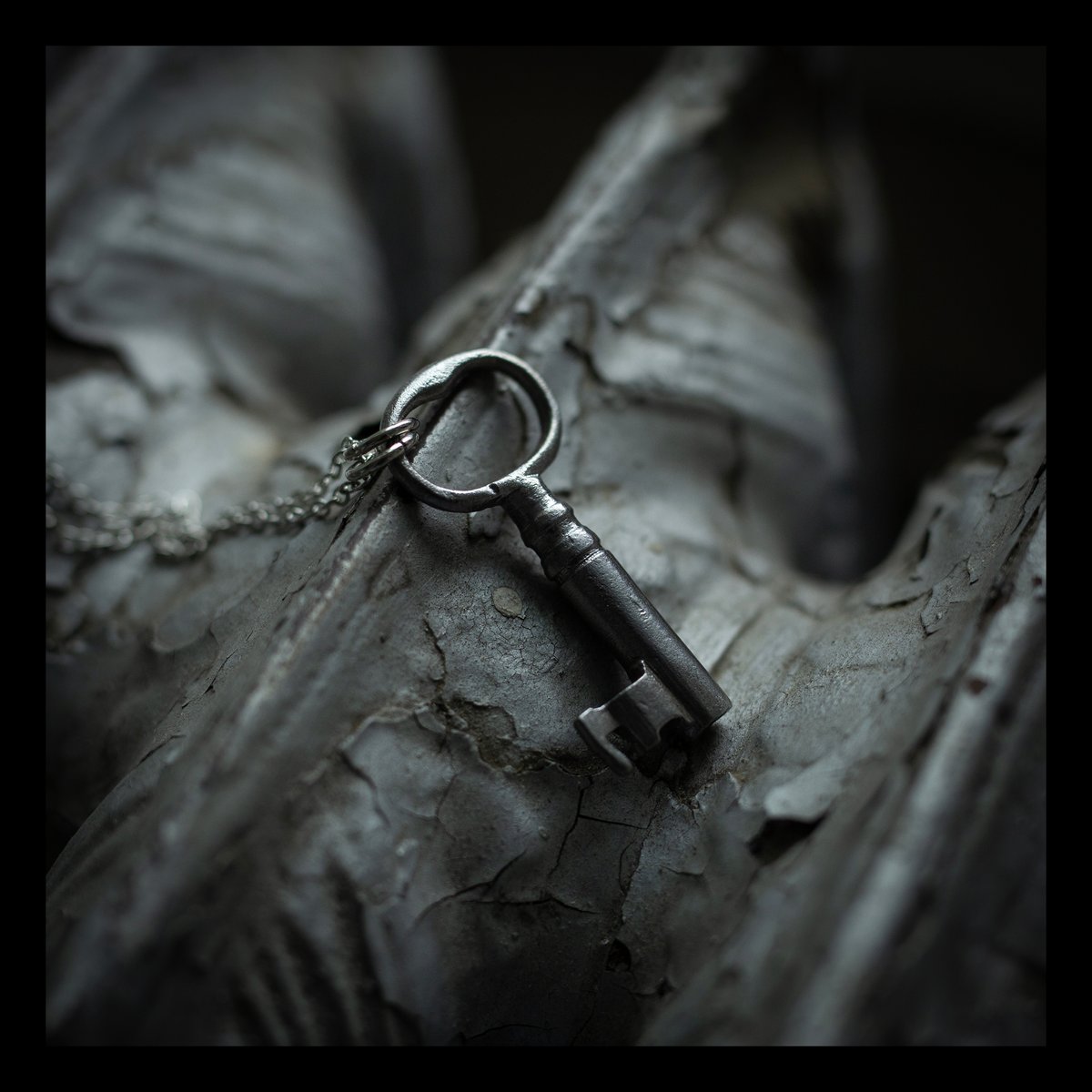 Small silver skeleton key necklace on silver chain