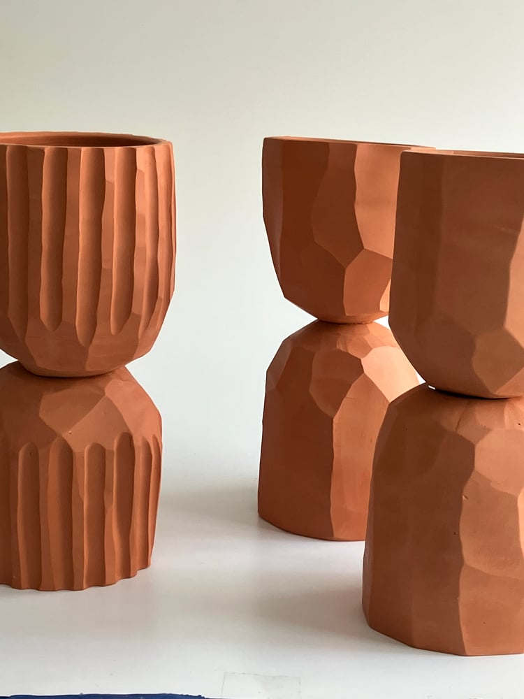 Image of three terracotta flowerpots