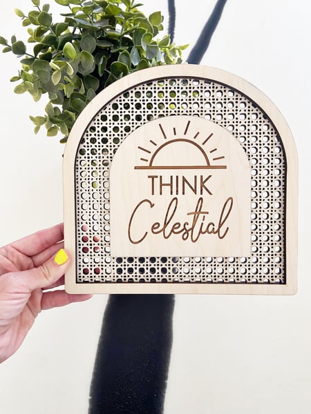 Image of “Think Celestial” faux rattan shelf sign