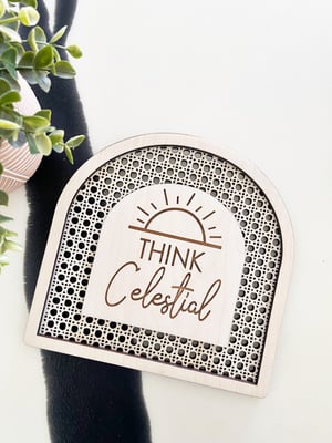 Image of “Think Celestial” faux rattan shelf sign