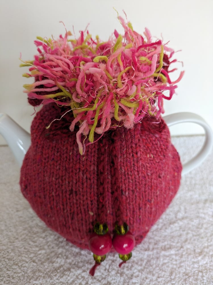 Image of large pink GO ON! tea cosie