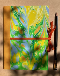 Image 1 of Bright yellow, Pale Orange and Fresh Green Hand-Marbled Thick Lined A5 Notebook- Daffodil Pattern