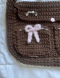 Image of brown bow messenger bag