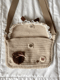 Image of lacy beige bear messenger bag