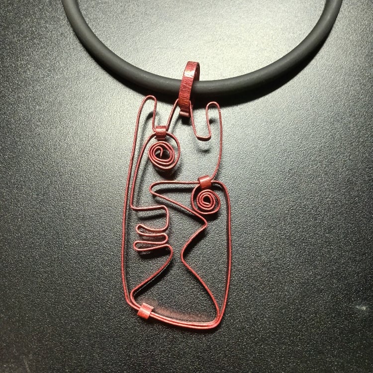 Image of burgundy face pendant 