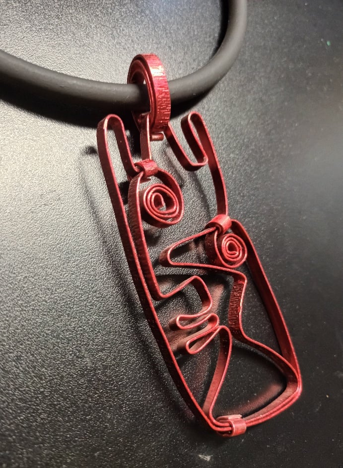 Image of burgundy face pendant