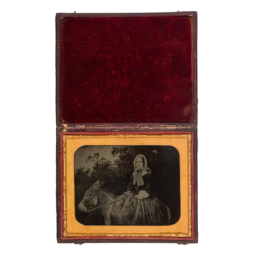 Image of Anonyme: ambrotype of a woman and a donkey, ca. 1860
