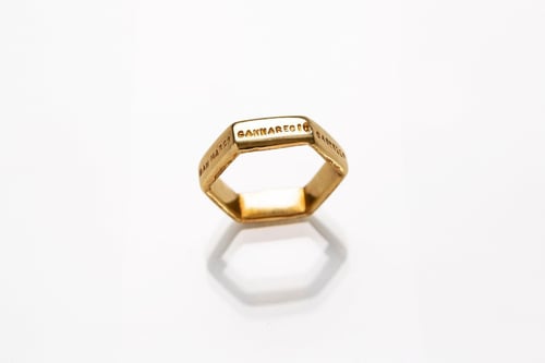 Image of gold plated silver hexagon ring with inscription in Latin 