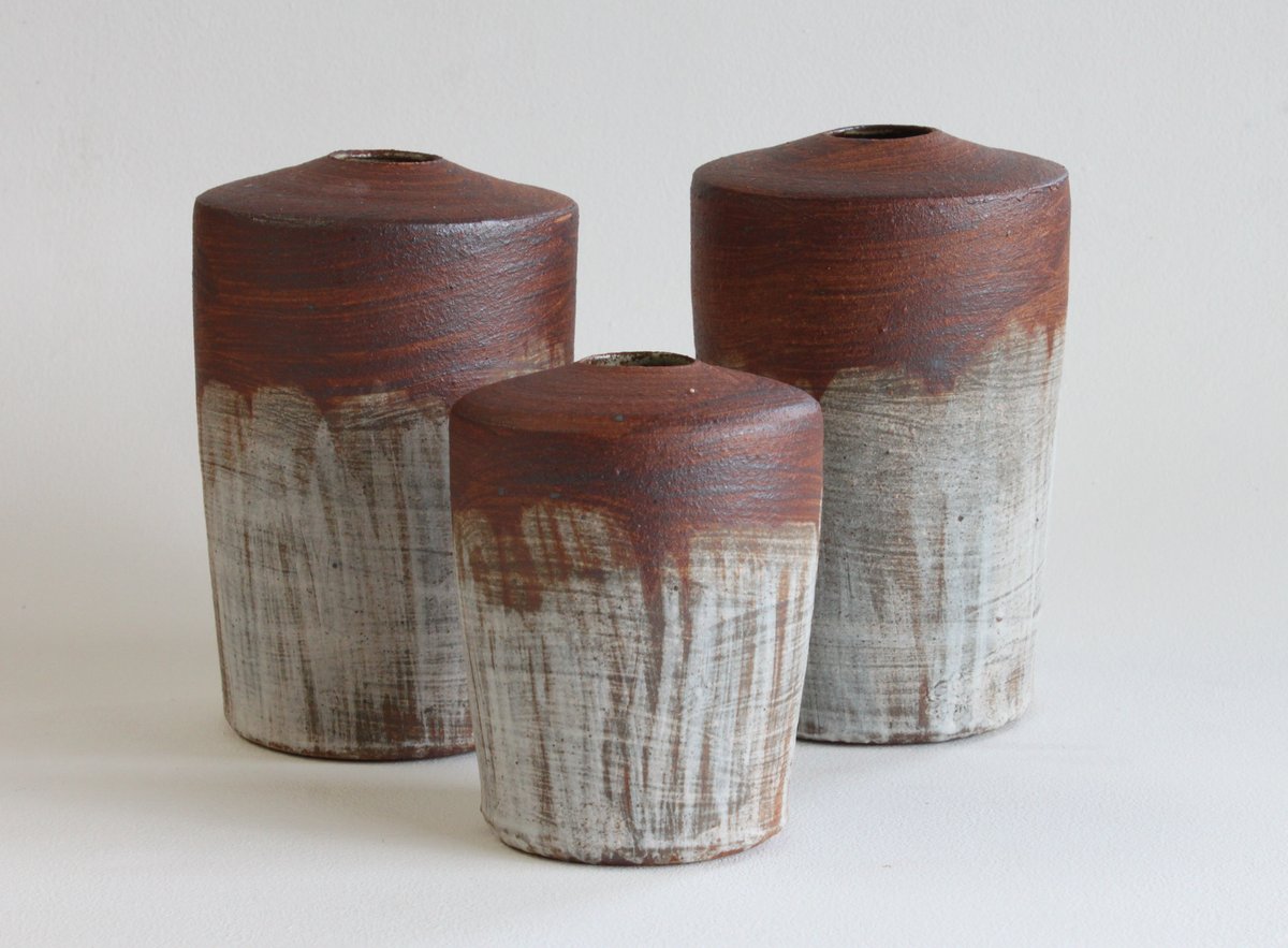 Image of Set of three stem vases with red and white slipped surfaces. 