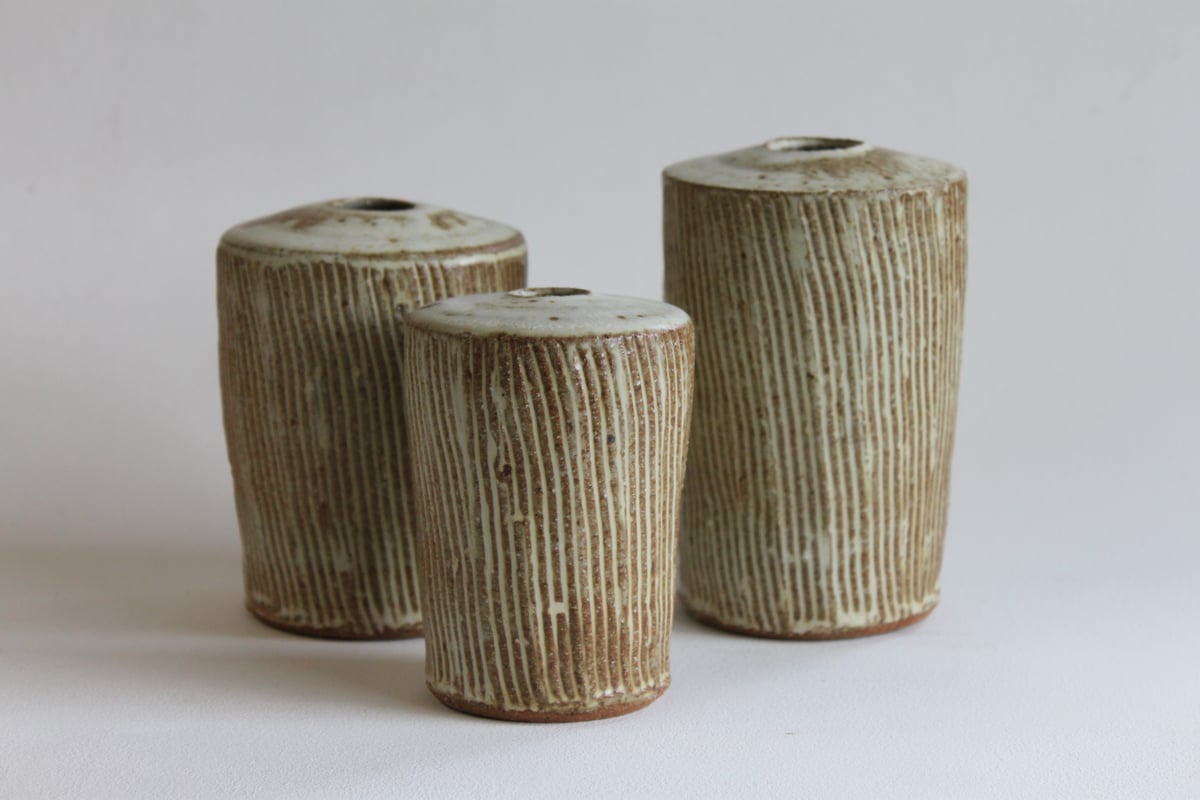 Image of Incised set of three stem Vases. 