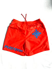 Image of beach day shorts in bright orange 