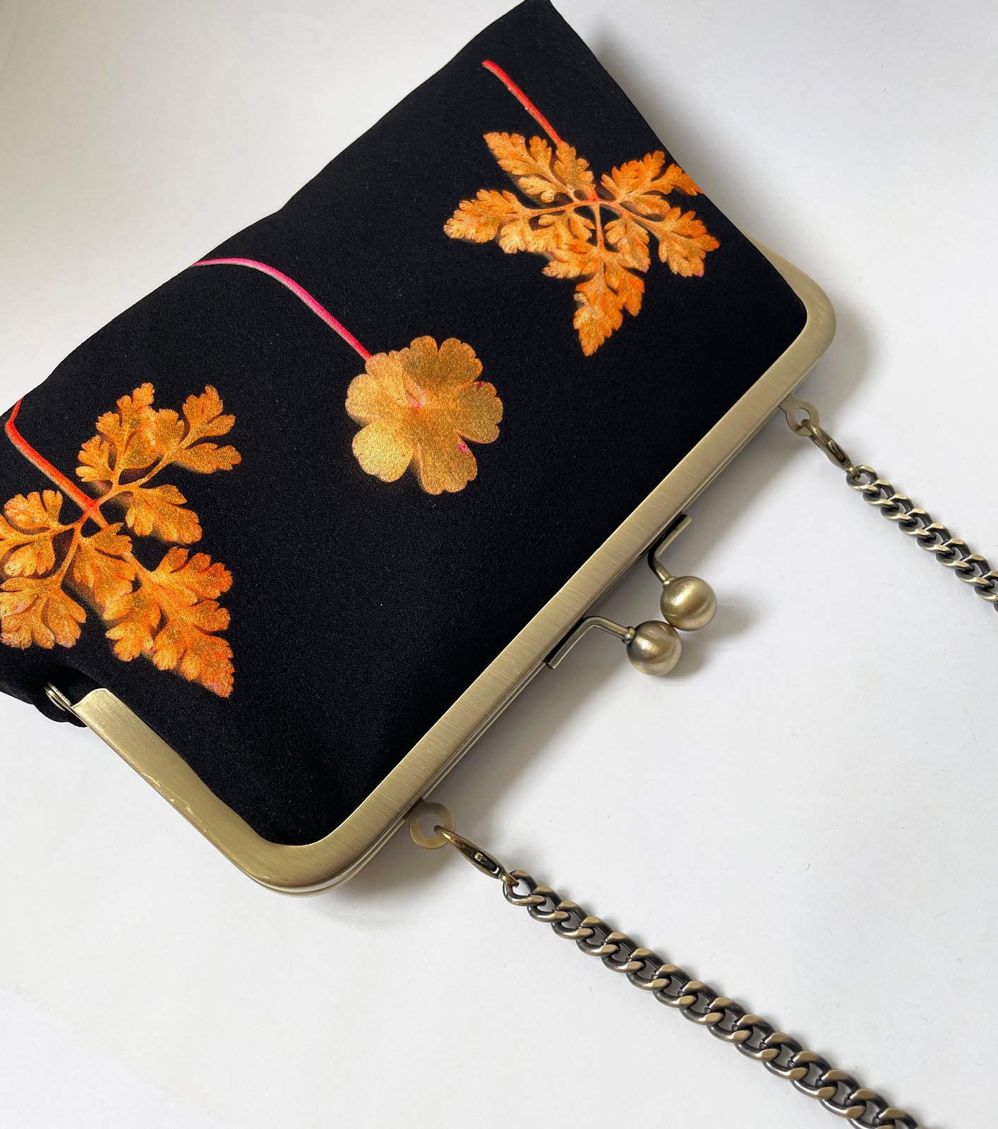 Orange and gold clutch bag on sale