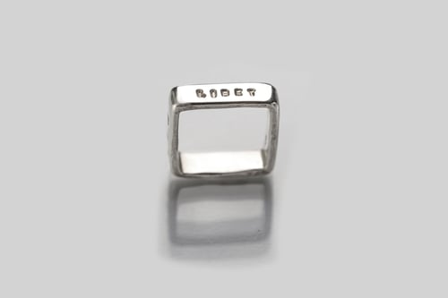 Image of polished  silver square ring with inscription in Latin