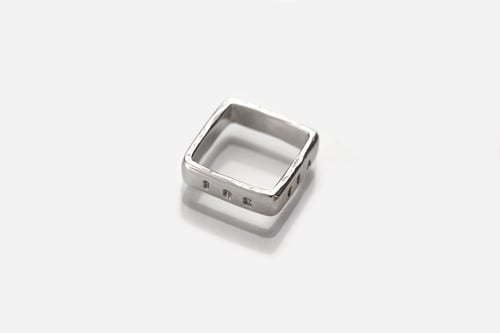 Image of polished  silver square ring with inscription in Latin