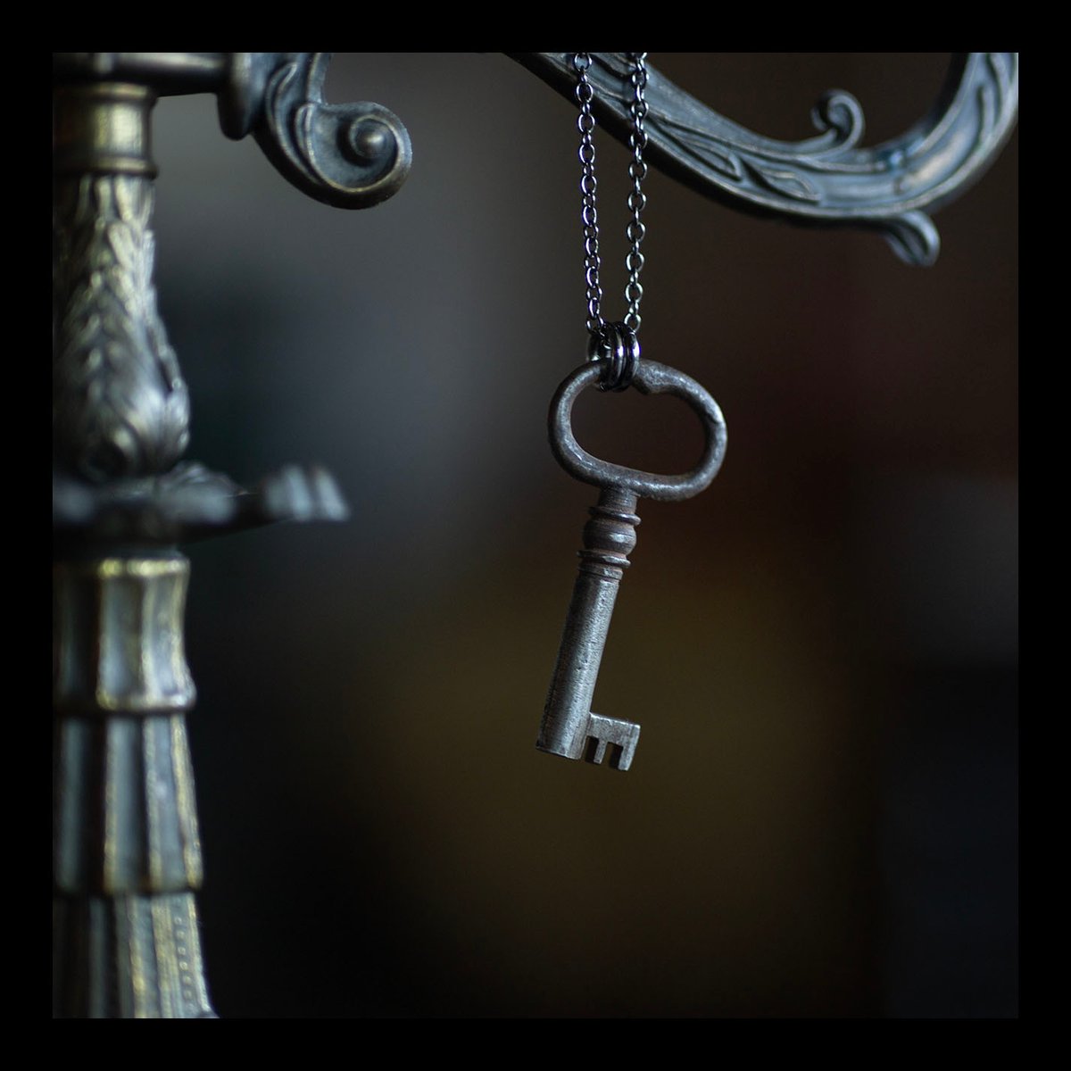 Dark silver skeleton key necklace on gunmetal chain