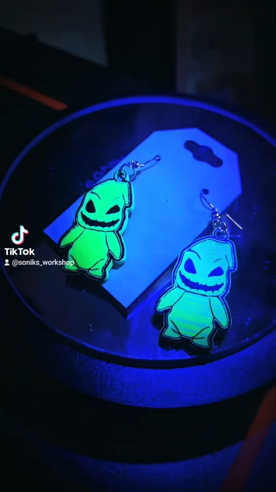 Image of Oogie Boogie UV earrings. 