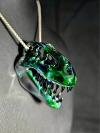 Image 2 of Expiramental green T-Rex skull pendant with galaxy teeth.