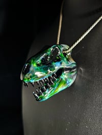 Image 3 of Expiramental green T-Rex skull pendant with galaxy teeth.