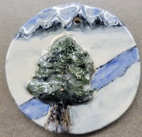 Tree and mountains ornament