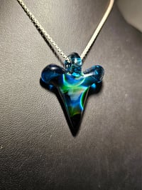 Image 2 of Shark tooth pendant made with expiramental green and blue stardust. 