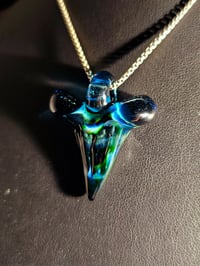 Image 1 of Shark tooth pendant made with expiramental green and blue stardust. 