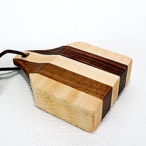 Image of Due Salt and Pepper Shaker holder and mini Walnut and Maple Cutting Board on the flip side