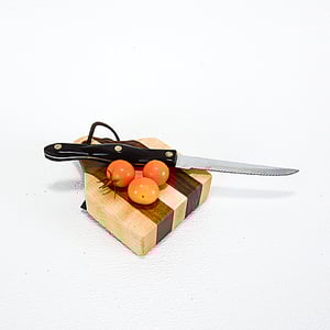 Image of Due Salt and Pepper Shaker holder and mini Walnut and Maple Cutting Board on the flip side