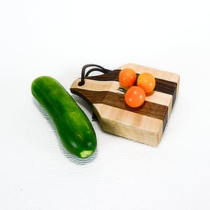 Image of Due Salt and Pepper Shaker holder and mini Walnut and Maple Cutting Board on the flip side