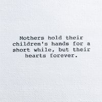 Image 1 of "Mothers hold their children's hands..." (0079)