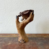 Image 2 of a handheld rose