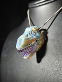 Image 1 of Mini mirage/royal jelly T-rex skull pendant. (CFL reactive)