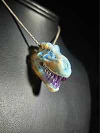 Image 2 of Mini mirage/royal jelly T-rex skull pendant. (CFL reactive)