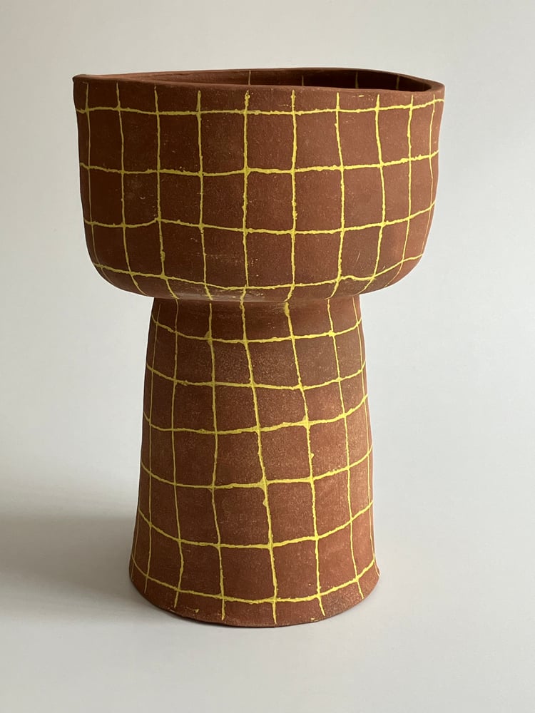 Image of tall yellow grid footed bowl