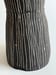 Image of tall black stoneware vessel