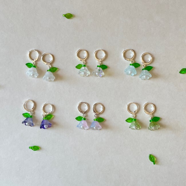 glass flower with green leaf huggie hoop earrings