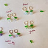 glass flower with green leaf huggie hoop earrings