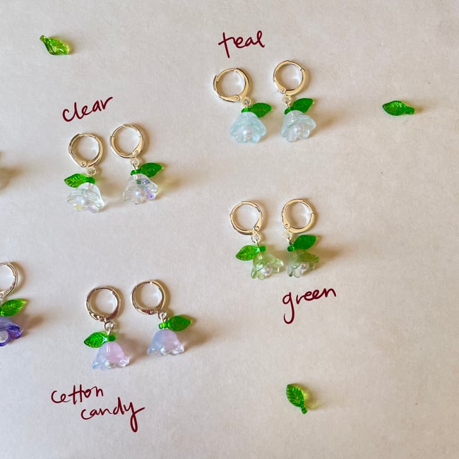 glass flower with green leaf huggie hoop earrings