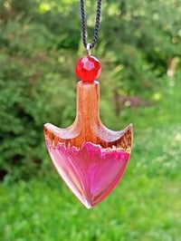 Image 1 of The arrowhead is made of epoxy resin and wood