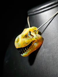 Image 1 of Ns yellow T-rex skull pendant. (Mini)